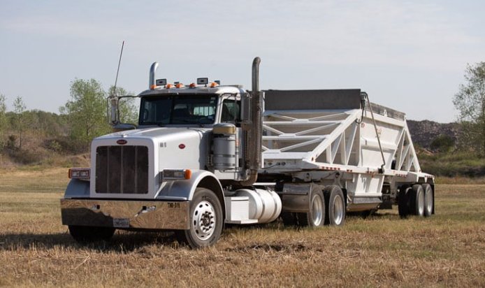 Sonny's belly dump trailer truck delivering aggregate materials